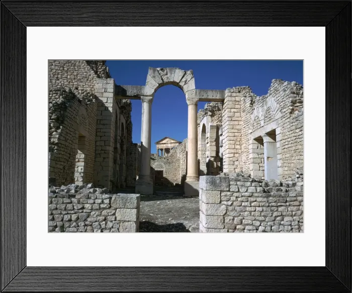 Framed Print : Distant Roman capitol of Dougga seen through an arch, 2nd century Framed Print : Distant Roman capitol of Dougga seen through an arch, 2nd century