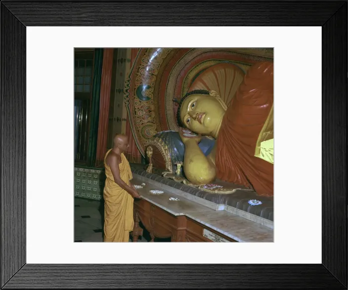 Framed Print : Buddhist priest before the image of a reclining Buddha Framed Print : Buddhist priest before the image of a reclining Buddha