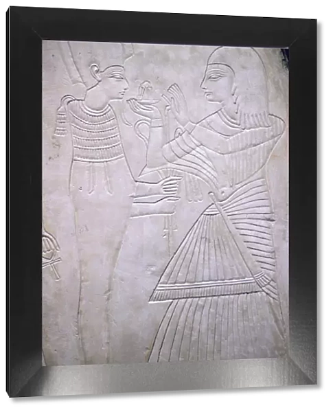 Egyptian relief of Amon making an offering to Osiris