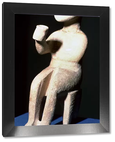 Cycladic marble seated figure holding a cup