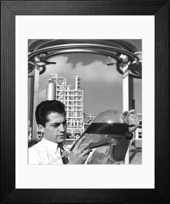 Framed Print : A laboratory worker holds a separating funnel of oil, Dunkirk refinery, France, 1950s Framed Print : A laboratory worker holds a separating funnel of oil, Dunkirk refinery, France, 1950s