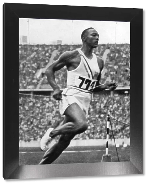 Jesse Owens at the end of the 100m at the Berlin Olympic Games, 1936