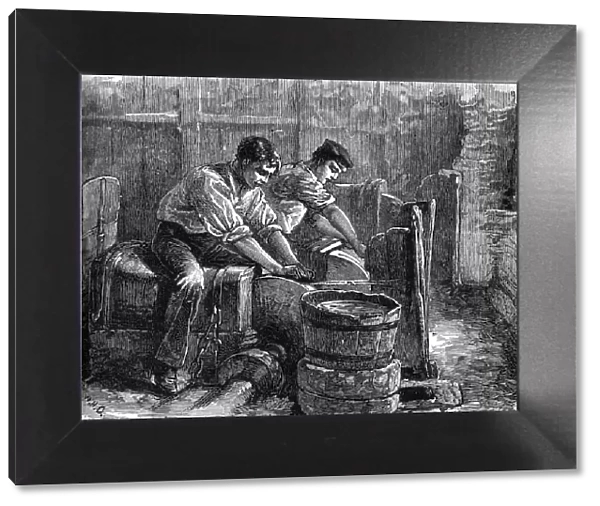 Grinders at work on a wheel, c1880