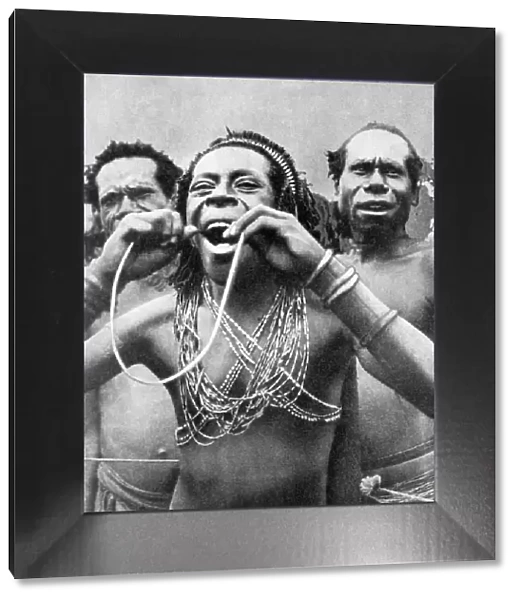 Swallowing canes in a ceremonial ritual, New Guinea, 1936. Artist: Wide World Photos