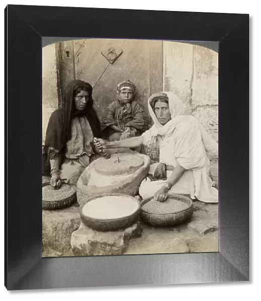 Women grinding at the mill, Palestine, 1900. Artist: Underwood & Underwood