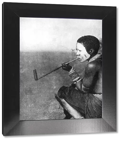 A South African tribesman smoking, 1936. Artist: South African Railways