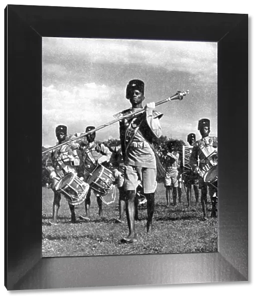 Bandsmen of the Northern Rhodesia Regiment beat a military tattoo, Zimbabwe, Africa, 1936. Artist: LNA Images