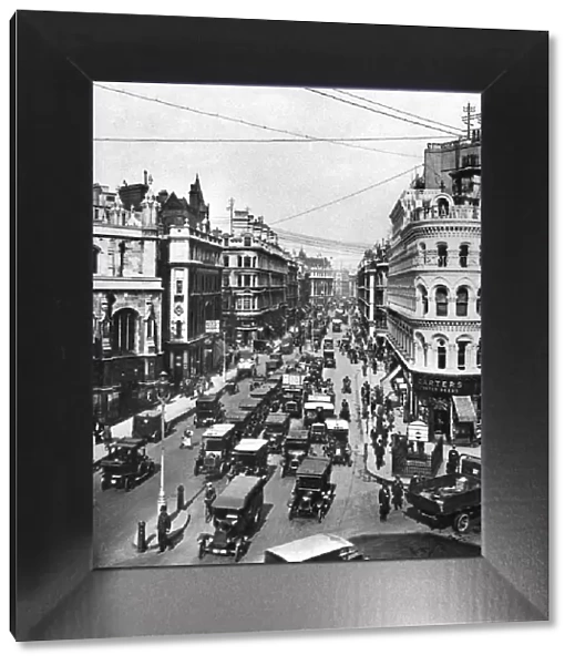 Queen Victoria Street at its intersection with Cannon Street, London, 1926-1927. Artist: Frith