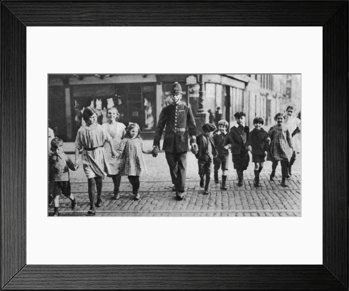 Framed Print : Policeman helping schoolchildren across the road, East End, London, 1926-1927 Framed Print : Policeman helping schoolchildren across the road, East End, London, 1926-1927