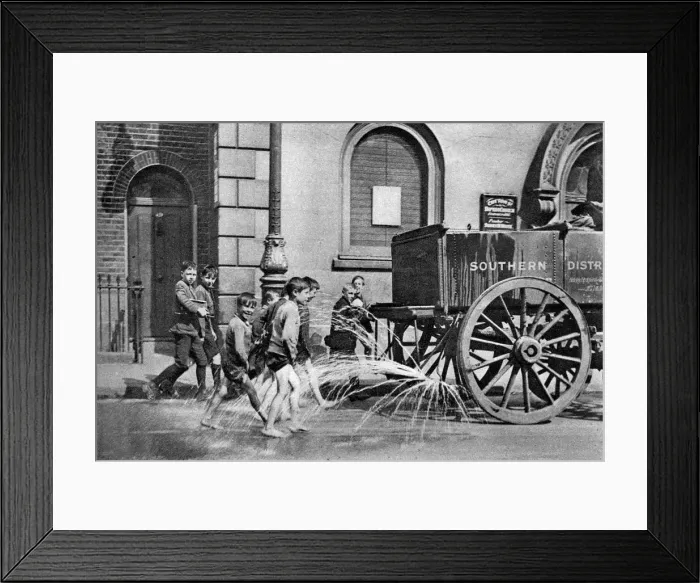 Framed Print : Boys following the Poplar Borough Council water cart, London, 1926-1927 Framed Print : Boys following the Poplar Borough Council water cart, London, 1926-1927