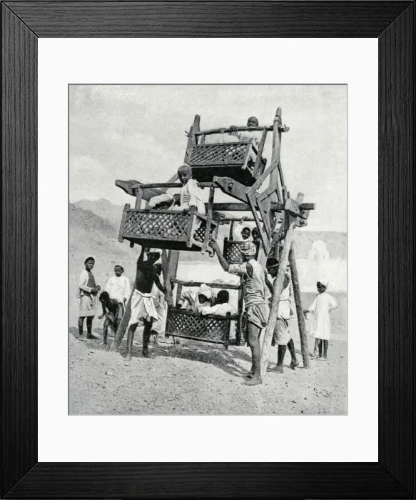 Framed Print : Arabian children enjoying a big-wheel, 1922 Framed Print : Arabian children enjoying a big-wheel, 1922