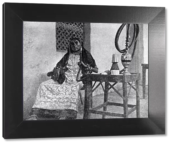 Somali woman smoking a hookah, Aden, 1922