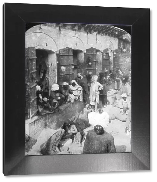 Indian women grinding corn between two round stones, Delhi, India, 1900s. Artist: Rose Stereographs