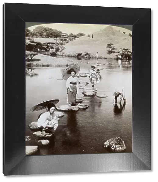 Women crossing the lake on stepping stones, Suizen-ji Garden, Kumamoto, Japan, 1904. Artist: Underwood & Underwood
