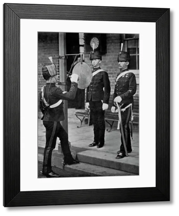 Framed Print : Striking the gong at the main gate of the Aldershot cavalry barracks, Hampshire, 1896. Artist: Gregory & Co Framed Print : Striking the gong at the main gate of the Aldershot cavalry barracks, Hampshire, 1896. Artist: Gregory & Co