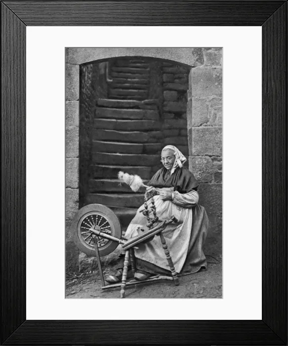 Framed Print : A woman at a spinning wheel, Dinan, Brittany, France, c1922 Framed Print : A woman at a spinning wheel, Dinan, Brittany, France, c1922