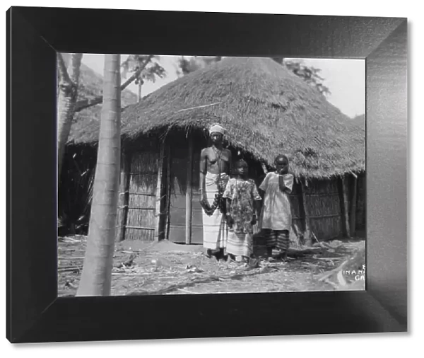 A family in front of their home, Gambia, 20th century