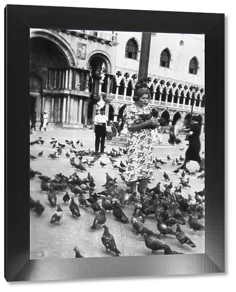 Woman surrounded by pigeons, St Marks Square, Venice, Italy, 1938