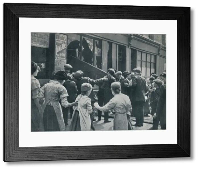 Framed Print : Anti-German rioting in London: A crowd breaking in the windows of a German shop, c1914 Framed Print : Anti-German rioting in London: A crowd breaking in the windows of a German shop, c1914
