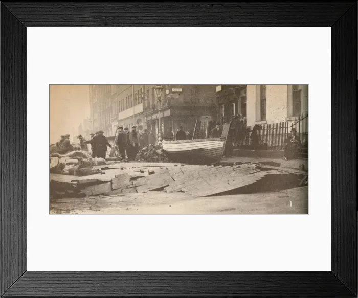 Framed Print : Damage caused on the Victoria Embankment when the Thames burst its banks and caused a number of fat Framed Print : Damage caused on the Victoria Embankment when the Thames burst its banks and caused a number of fat