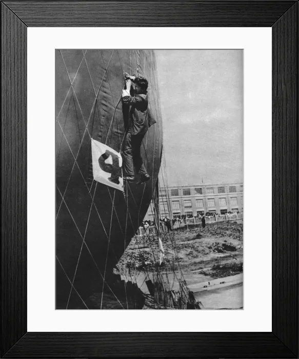 Framed Print : Making adjustments to the net of a balloon before attaching the basket, c1935 (c1937) Framed Print : Making adjustments to the net of a balloon before attaching the basket, c1935 (c1937)