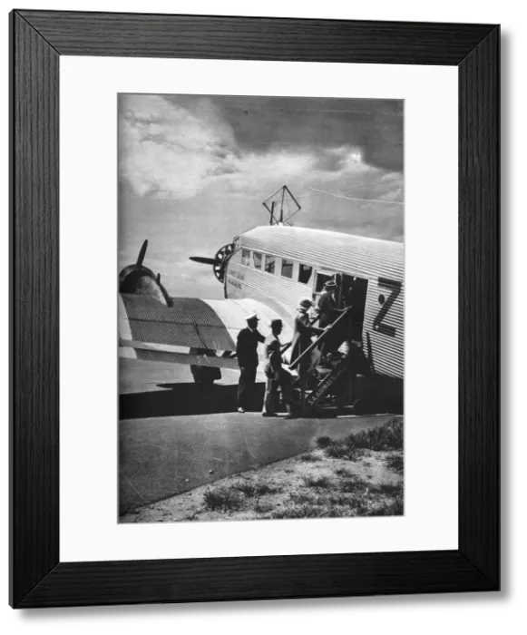 Framed Print : Passengers boarding one of the Junkers airliners of South African Airways, c1936 (c1937) Framed Print : Passengers boarding one of the Junkers airliners of South African Airways, c1936 (c1937)