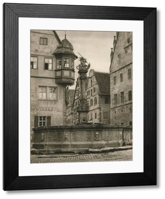 Framed Print : Rothenburg o. d. T. - St. Georges Fountain - Marien-Apotheke, 1931. Artist: Kurt Hielscher Framed Print : Rothenburg o. d. T. - St. Georges Fountain - Marien-Apotheke, 1931. Artist: Kurt Hielscher