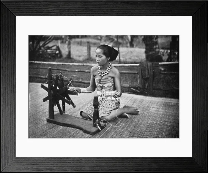 Framed Print : A Dayak girl at her spinning wheel, 1902 Framed Print : A Dayak girl at her spinning wheel, 1902