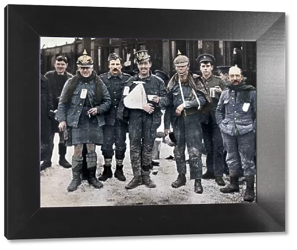 Some cheerful wounded from the Neuve Chapelle fighting, wearing captured German helmets, 1915