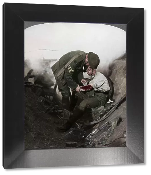Soldier receiving first aid from a sergeant in a sap, Battle of Peronne, World War I, 1914-1918. Artist: Realistic Travels Publishers