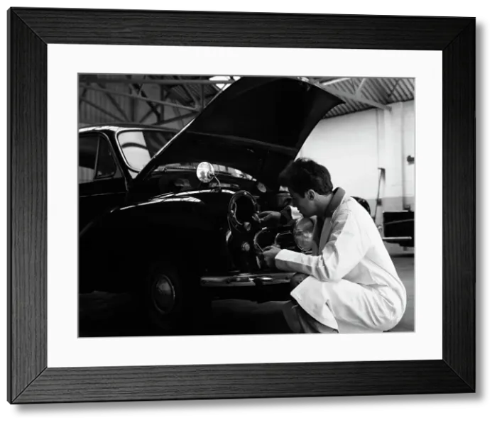 Framed Print : Auto electrician changing a light bulb on a Morris Minor, Nottingham, Nottinghamshire, 1961 Framed Print : Auto electrician changing a light bulb on a Morris Minor, Nottingham, Nottinghamshire, 1961