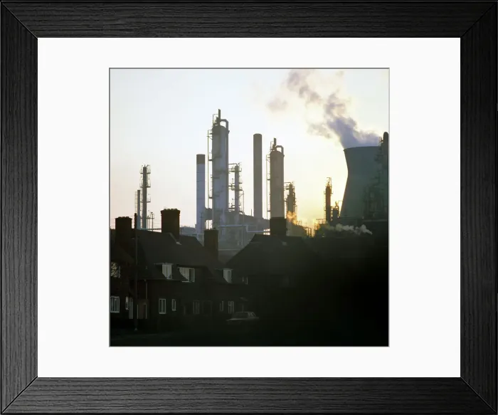 Framed Print : A petrochemical plant towering over residential housing, Baglan Bay, Wales, 1975 Framed Print : A petrochemical plant towering over residential housing, Baglan Bay, Wales, 1975