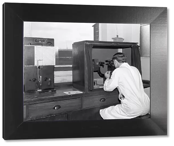 A lab tachnician with a Reichter Microscope at a steelworks, Sheffield, South Yorkshire, 1962