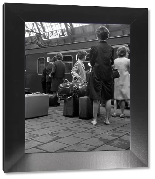 Passengers on a platform at Centraal Station, Amsterdam, Netherlands, 1963. Artist