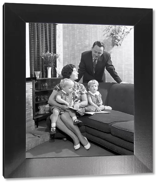 Family group looking at a brochure, Doncaster, South Yorkshire, 1963