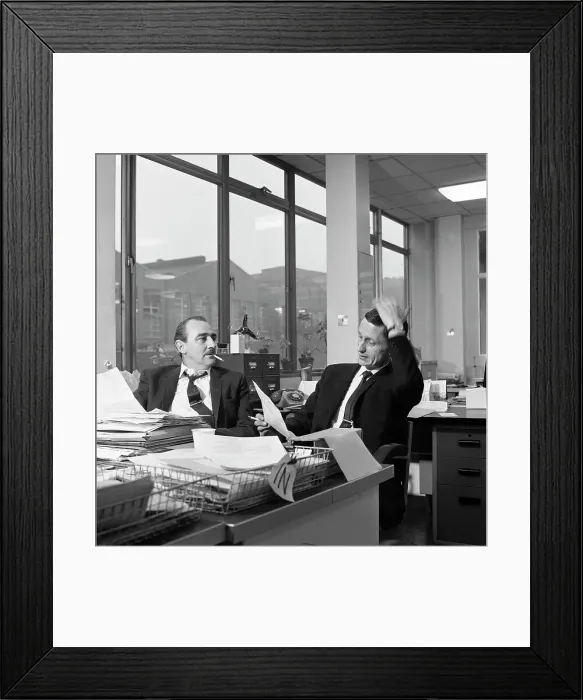 Framed Print : Lost order? two salesmen try to sort out the orders over a cigarette, 1967. Artist Framed Print : Lost order? two salesmen try to sort out the orders over a cigarette, 1967. Artist