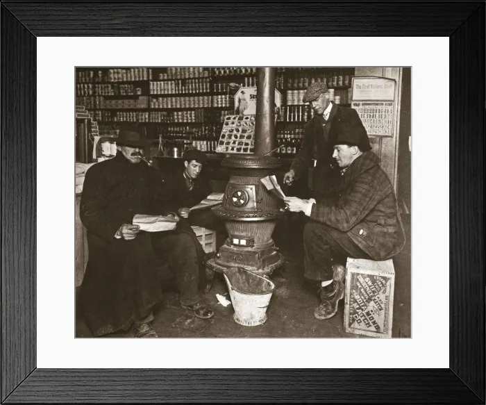 Framed Print : A group of men around a stove in a shop, USA, c1910 Framed Print : A group of men around a stove in a shop, USA, c1910