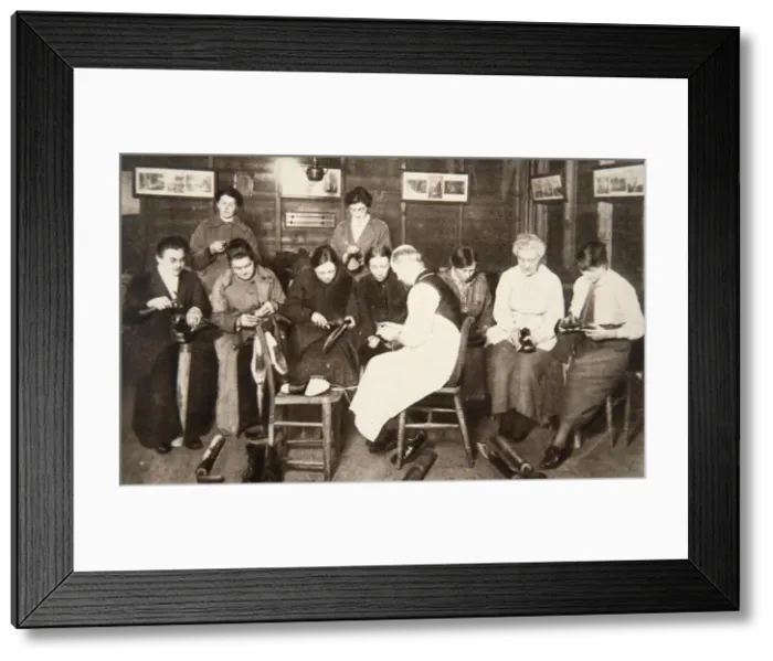 Framed Print : A group of women receive a lesson in boot repairing, World War I, c1914-c1918. Artist Framed Print : A group of women receive a lesson in boot repairing, World War I, c1914-c1918. Artist