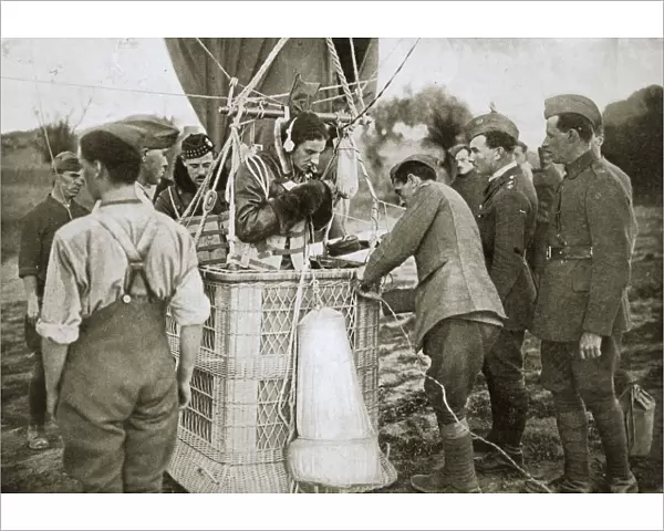 Observer of a kite-balloon testing the telephone before ascending, France, World War I, 1916