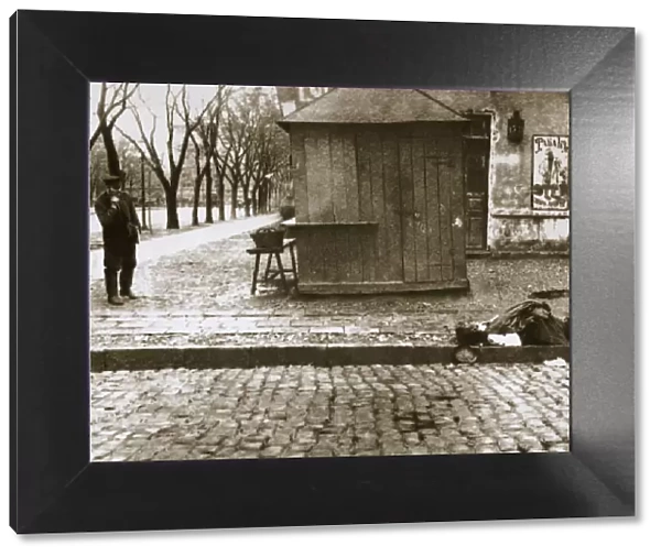 An onlooker observes a dead man left in the streets, Russia, early 20th century. Artist