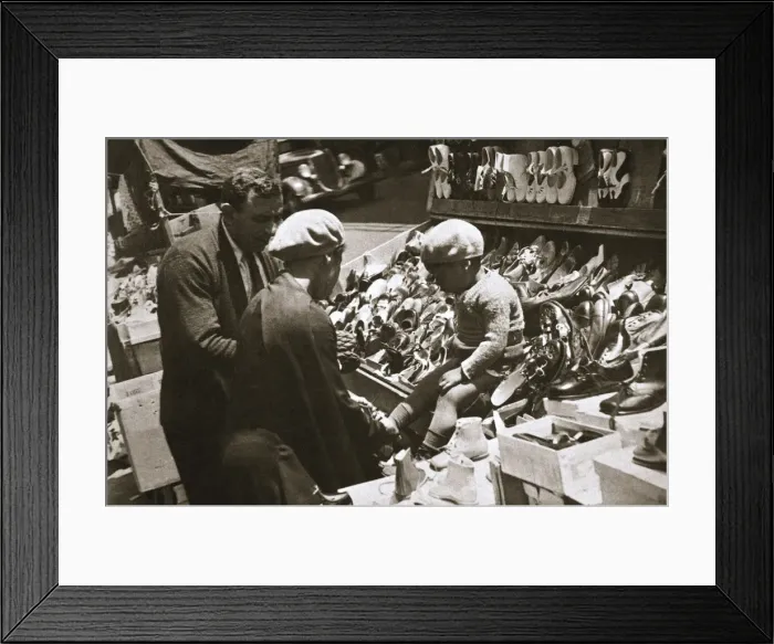 Framed Print : A woman from Harlem buys a pair of shoes for her child, New York, USA, c1920s-c1930s Framed Print : A woman from Harlem buys a pair of shoes for her child, New York, USA, c1920s-c1930s