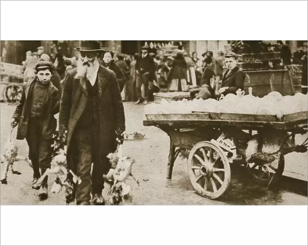 Old Jewish man and his grandson carrying some fowls, Wentworth Street, Stepney, 20th century
