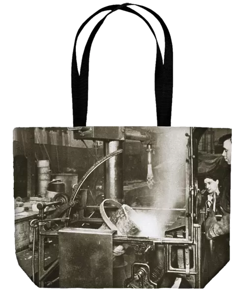 Making money; lowering a pot of liquid metal into a machine, 20th century. Artist