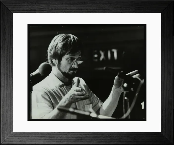 Framed Print : Michael Garrick conducting an orchestra at Berkhamsted Civic Centre, 1985. Artist