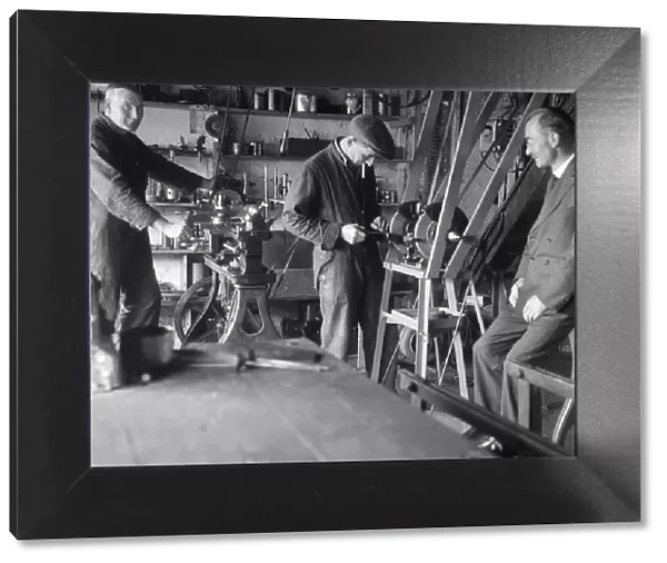 Geoffrey Baker with two other men in a workshop. Artist: Bill Brunell
