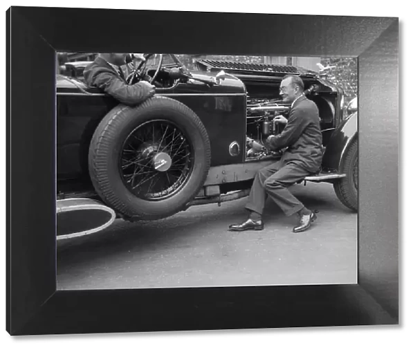 Geoffrey Baker inspecting the engine of a Minerva car. Artist: Bill Brunell