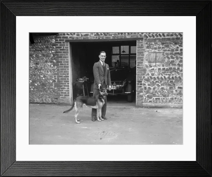 Framed Print : Geoffrey Baker and his alsatian. Artist: Bill Brunell Framed Print : Geoffrey Baker and his alsatian. Artist: Bill Brunell