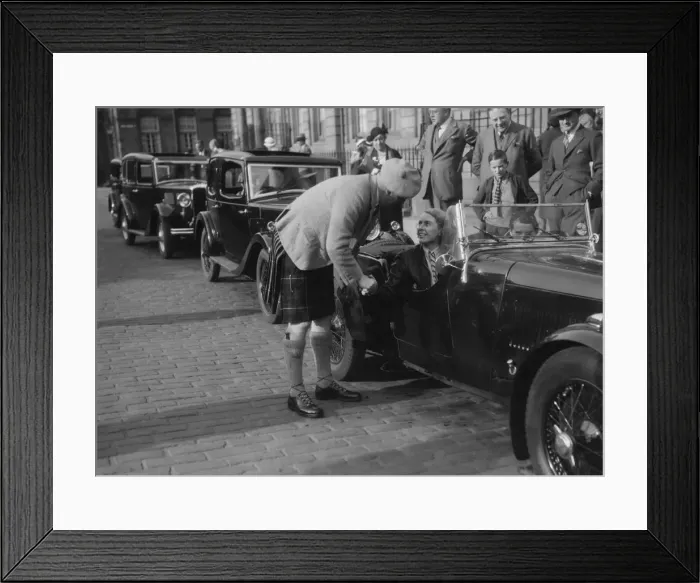 Framed Print : Kitty Brunell in her Aston Martin, chatting to a man in Highland dress, RSAC Scottish Rally, 1933 Framed Print : Kitty Brunell in her Aston Martin, chatting to a man in Highland dress, RSAC Scottish Rally, 1933