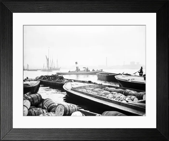 Framed Print : Steam tug moving between barges on the Thames, London, c1905 Framed Print : Steam tug moving between barges on the Thames, London, c1905