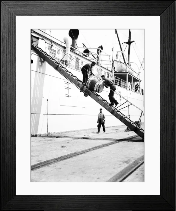 Framed Print : Unloading a barrel from a ship down a gangway, London, c1905 Framed Print : Unloading a barrel from a ship down a gangway, London, c1905